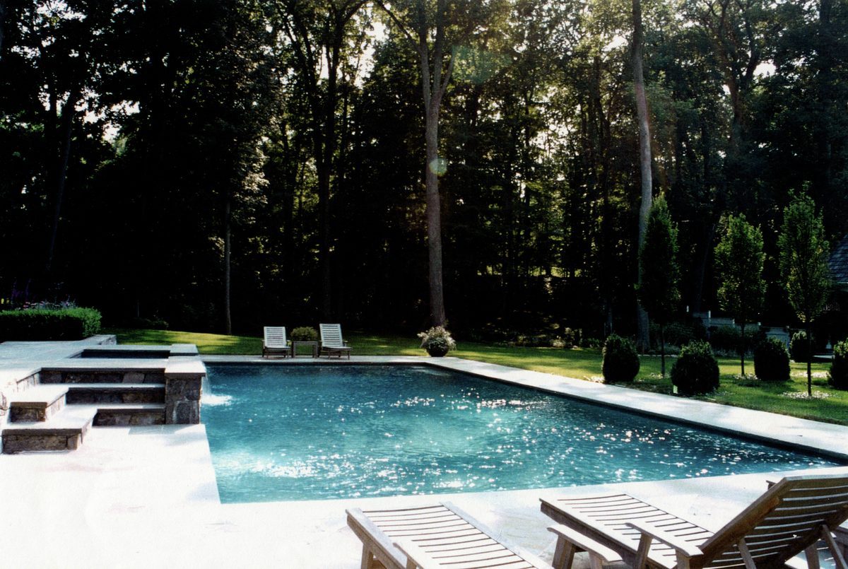 Luxury pool with stone surround and manicured estate grounds